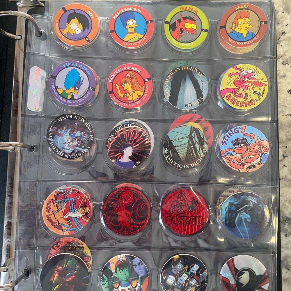 Lot of 37 Vintage Pogs With Protector Sheets